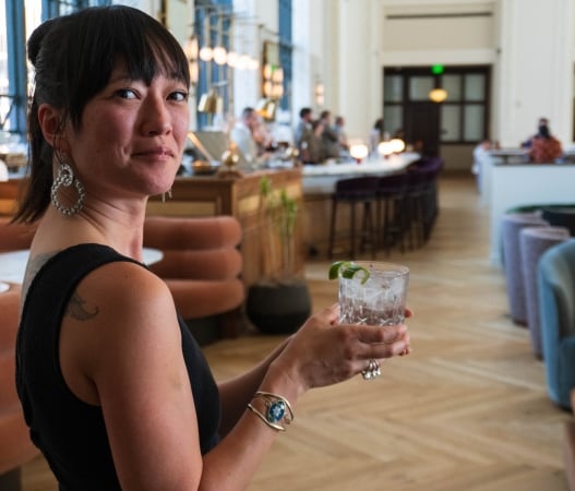 a woman carrying a cocktail inside denver union station