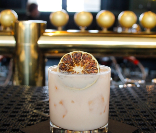 a cocktail sitting on a bar top