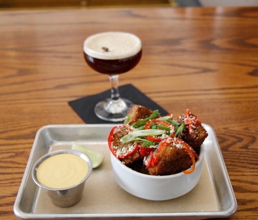a plate of food sitting in front of a cocktail