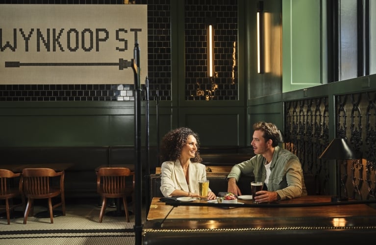 two people talking and enjoying drinks at the terminal bar
