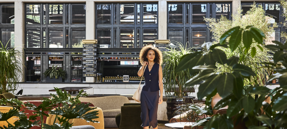 a woman talking through the great hall at Denver Union Station