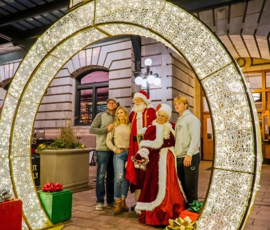 Santa and Ms. Claus pose with children