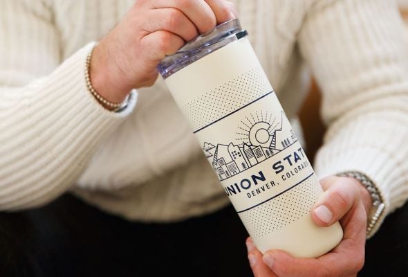 Man holding a Denver Union Station mug