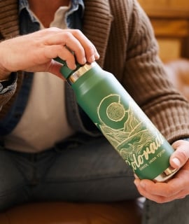 Male hold a Colorado water mug