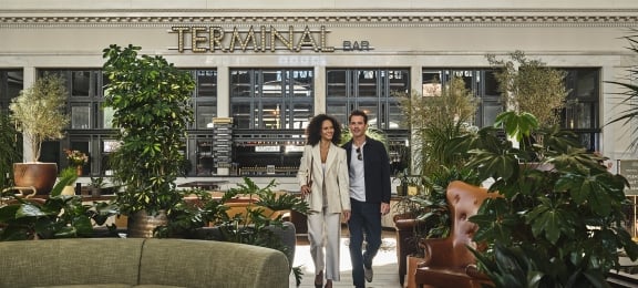 a couple walking through the great hall at Denver Union Station