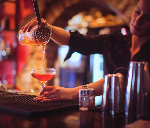 A bartender pouring a cocktail at The Cruise Room in Denver, Colorado.
