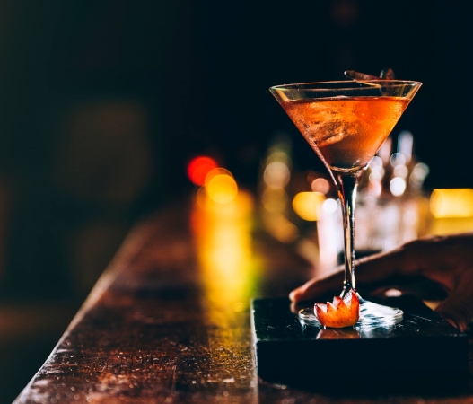 A cocktail being presented at the bar of Williams & Graham in Denver Colorado.