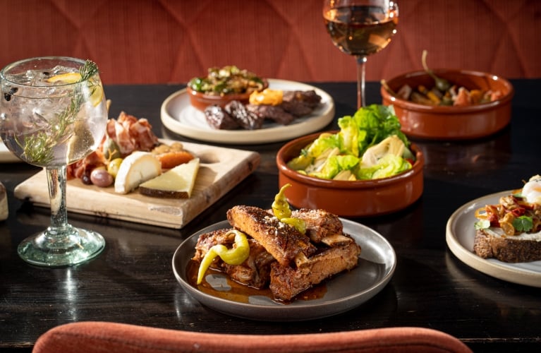 Ribs, charcuterie board, salad and mixed drinks served at Ultreia, Denver